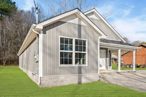 a view of house with yard