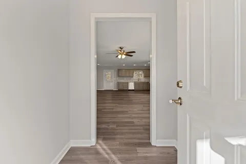a view of empty room with wooden floor and window