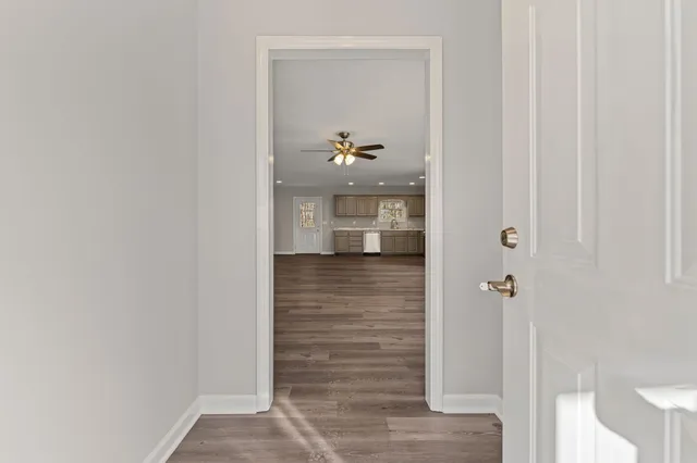 a view of empty room with wooden floor and window