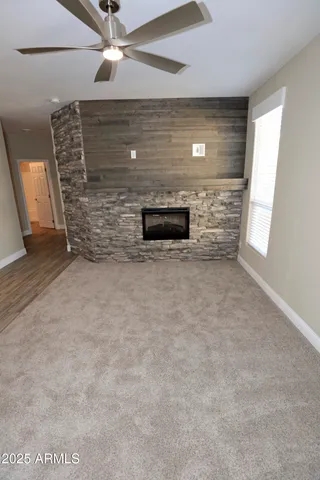 a view of empty room with a fireplace