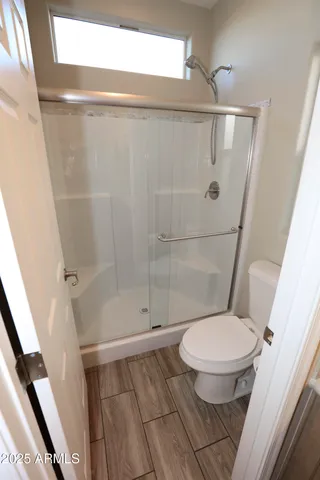 a white toilet sitting next to a bathroom sink