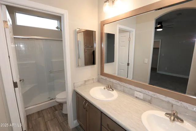 a bathroom with a sink toilet and shower
