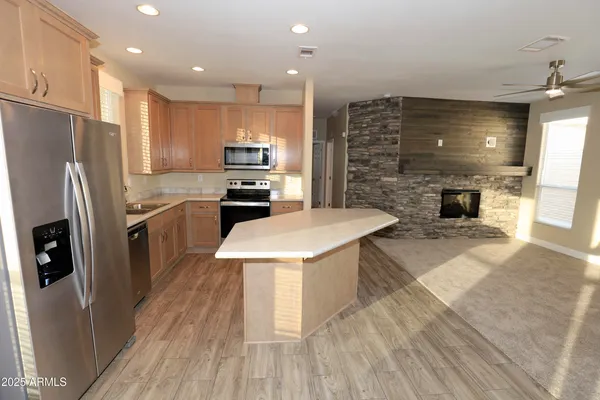 a kitchen with stainless steel appliances a refrigerator a stove top oven and sink