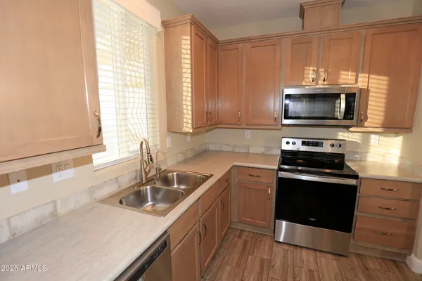 a kitchen with a sink stove and microwave
