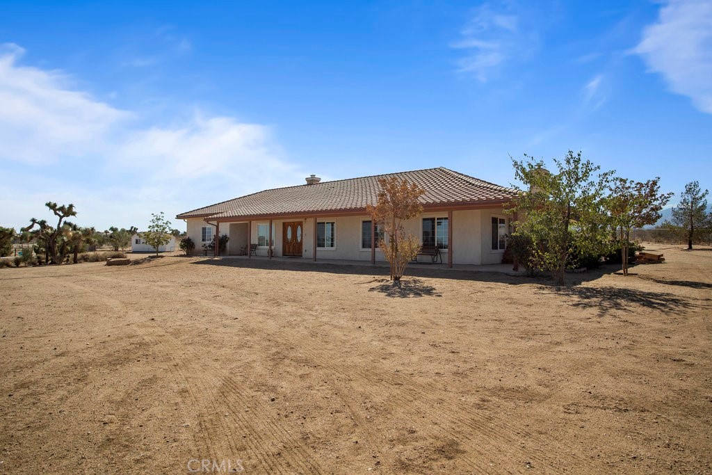 8675 Appleton Street Victorville, CA 92392 - Photo 1 of 1 a house with trees in front of it
