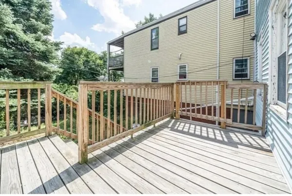 a view of a wooden deck with a barbeque