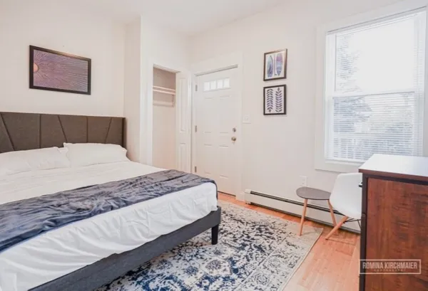 a bedroom with a bed and a window