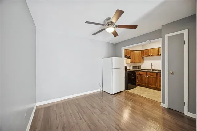 a kitchen with a refrigerator and a stove top oven
