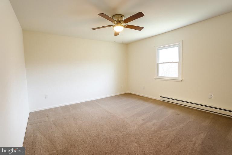 12102 Lucasville Road Manassas, VA 20112 - Photo 14 of 22 an empty room with a window and a ceiling fan