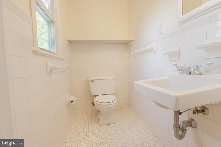 12102 Lucasville Road Manassas, VA 20112 - Photo 15 of 22 a white toilet sitting next to a bathroom sink
