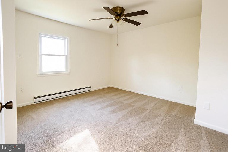 12102 Lucasville Road Manassas, VA 20112 - Photo 17 of 22 an empty room with a window and a ceiling fan