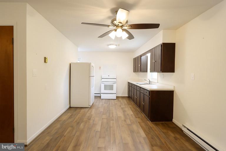 12102 Lucasville Road Manassas, VA 20112 - Photo 10 of 22 a view of kitchen with refrigerator microwave and cabinets
