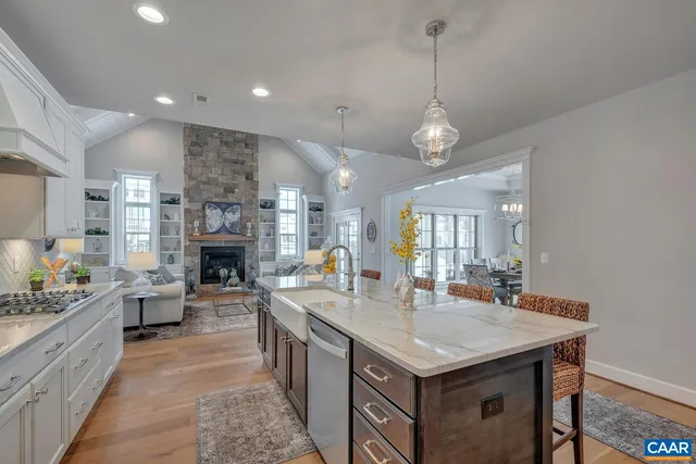 a kitchen with stainless steel appliances granite countertop a stove and cabinets