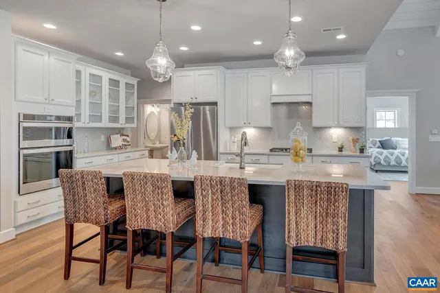 a large kitchen with kitchen island a dining table and chairs