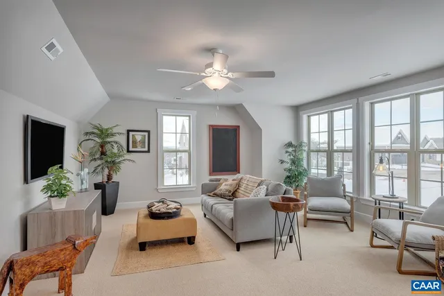 a view of a dining room with furniture and a potted plant