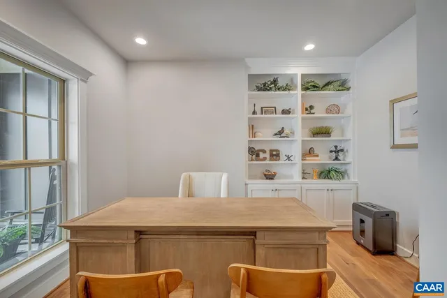 a view of a kitchen with furniture and wooden floor