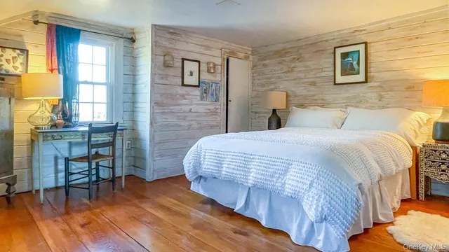 a bedroom with a bed and a table in it