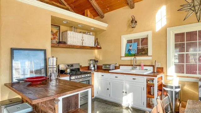 a kitchen with a sink stove and cabinets