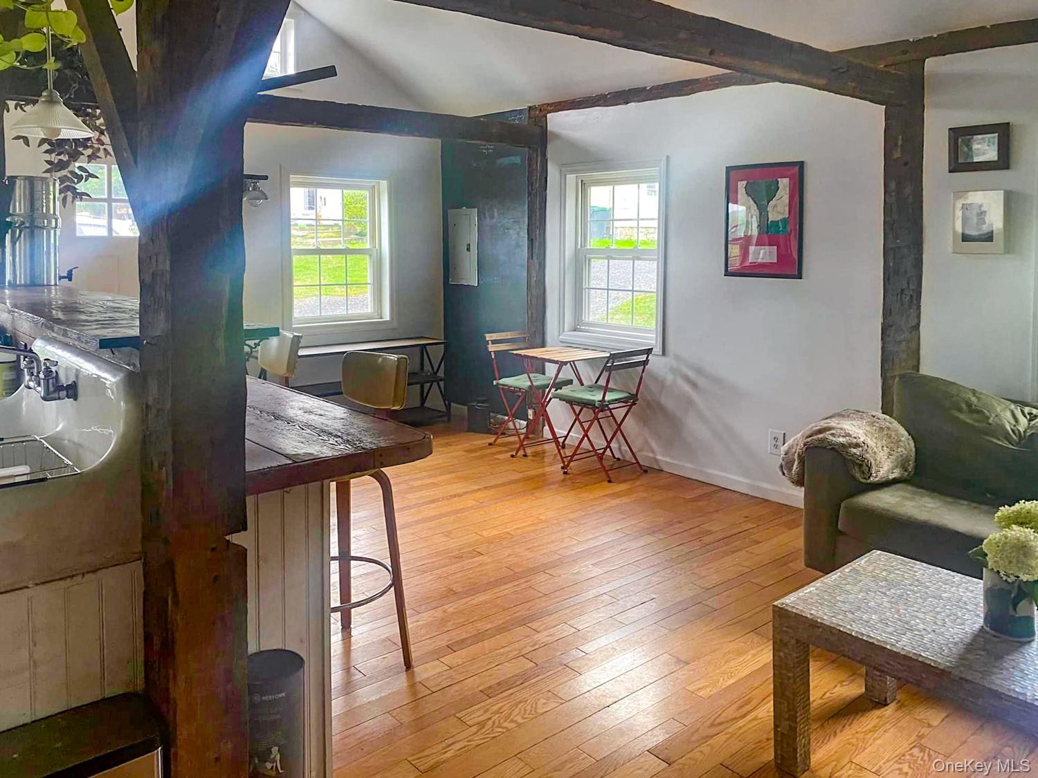 1201 Bruynswick Road Gardiner, NY 12525 - Photo 33 of 45 a living room with furniture and a wooden floor