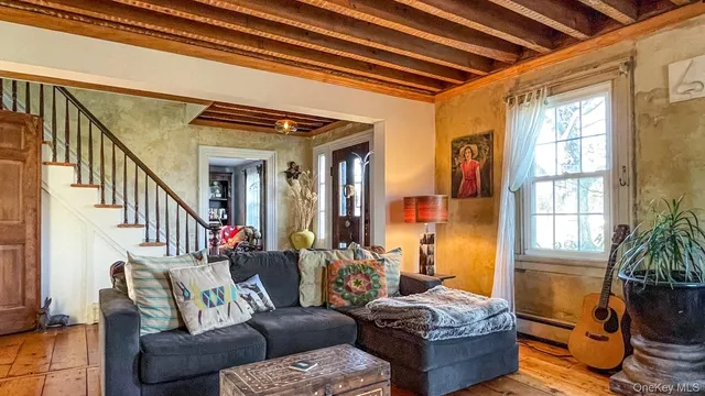 a living room with furniture and a potted plant