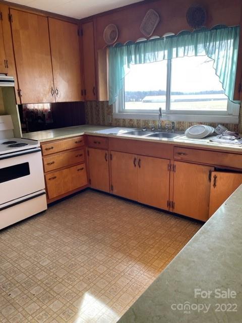2408 McCraw Road Mooresboro, NC 28114 - Photo 3 of 13 a kitchen with granite countertop white cabinets and a sink