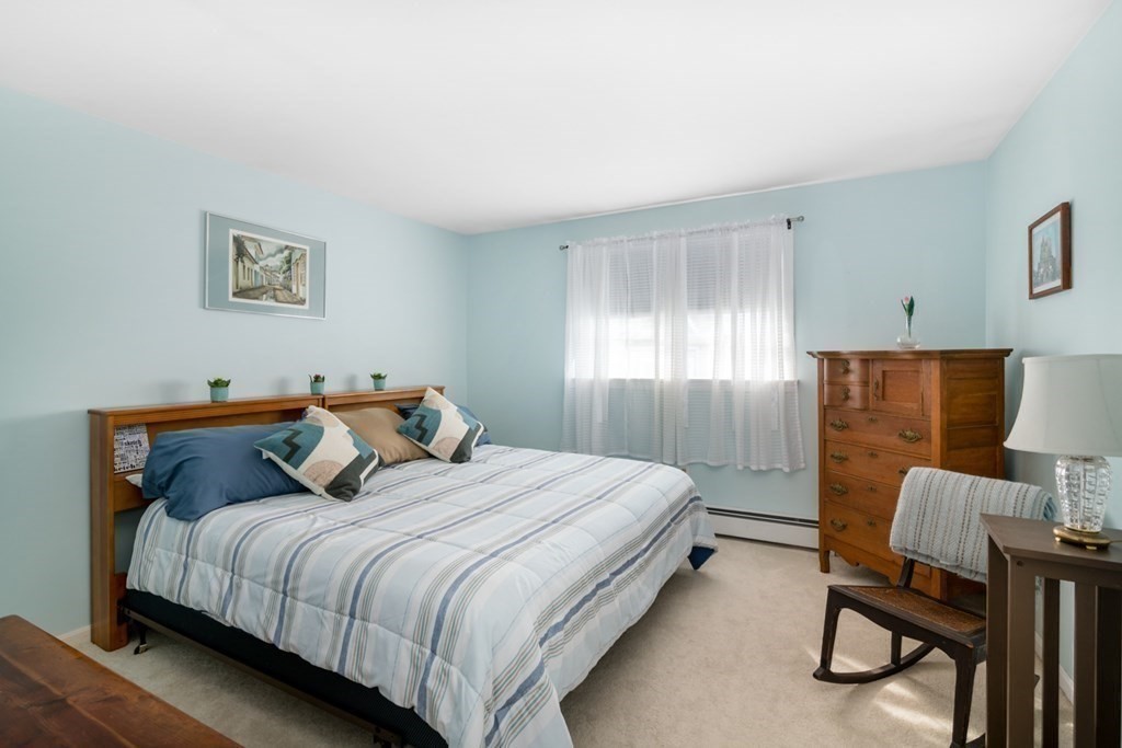 16 Marina Drive, Unit 16 Hull, MA 02045 - Photo 12 of 22 a bedroom with a bed and a chair