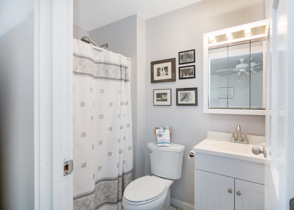 16 Marina Drive, Unit 16 Hull, MA 02045 - Photo 14 of 22 a white toilet sitting next to a bathroom sink