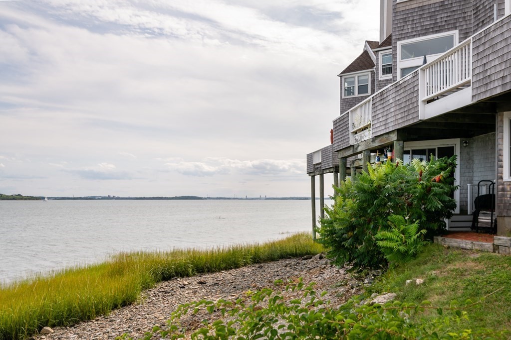 16 Marina Drive, Unit 16 Hull, MA 02045 - Photo 17 of 22 a view of a lake with a big yard and large trees