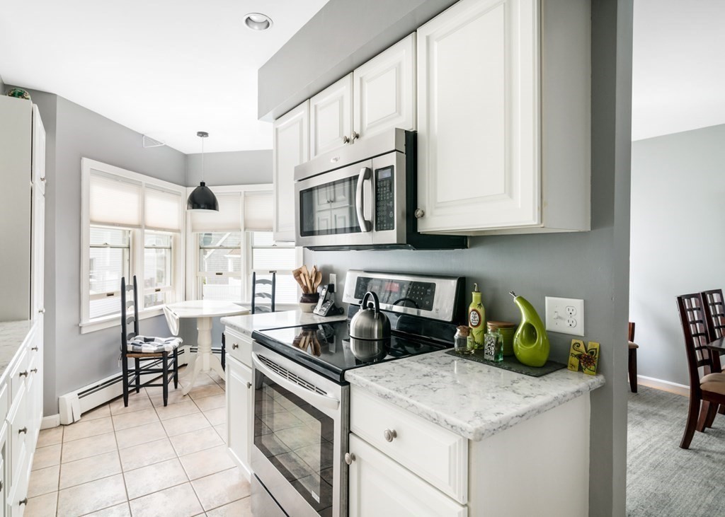 16 Marina Drive, Unit 16 Hull, MA 02045 - Photo 5 of 22 a kitchen with stainless steel appliances granite countertop a sink stove and cabinets
