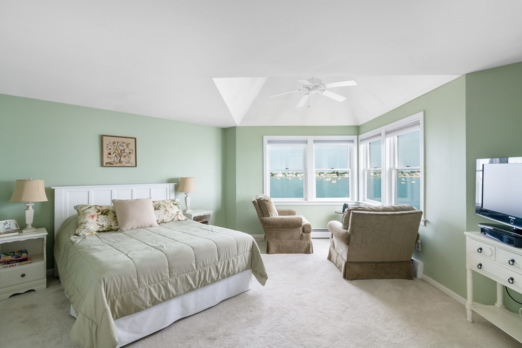 16 Marina Drive, Unit 16 Hull, MA 02045 - Photo 10 of 22 a bedroom with a bed and a flat screen tv