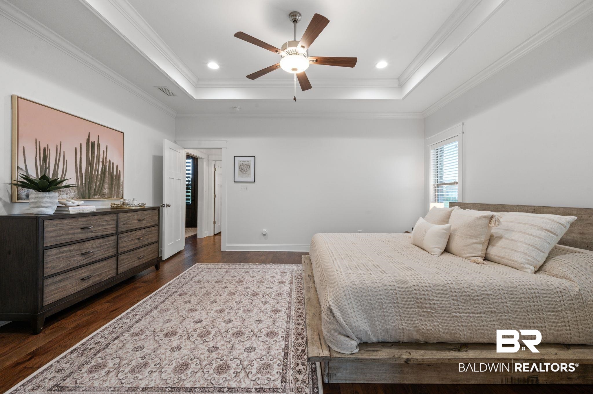 418 Fortune Drive Fairhope, AL 36532 - Photo 23 of 63 Bedroom featuring dark hardwood / wood-style floors, a raised ceiling, ornamental molding, and ceiling fan