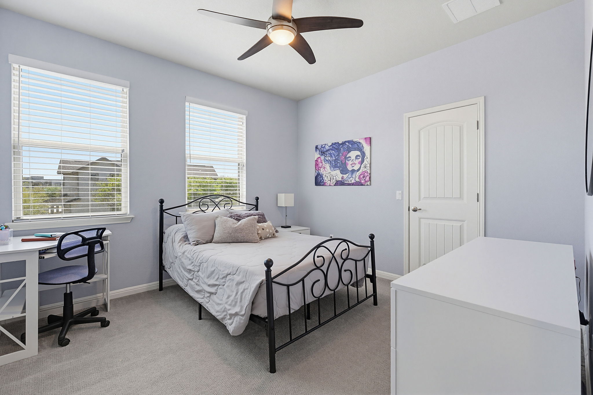 5820 Baythorne Drive Austin, TX 78747 - Photo 16 of 32 a bedroom with a bed and a chandelier