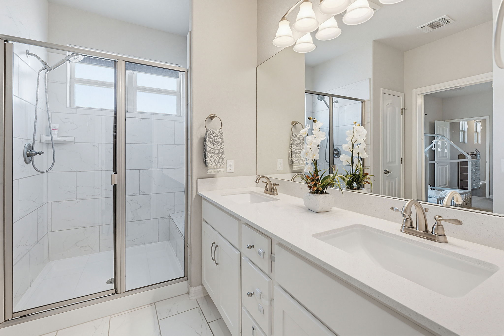 5820 Baythorne Drive Austin, TX 78747 - Photo 18 of 32 a bathroom with a double vanity sink mirror and shower