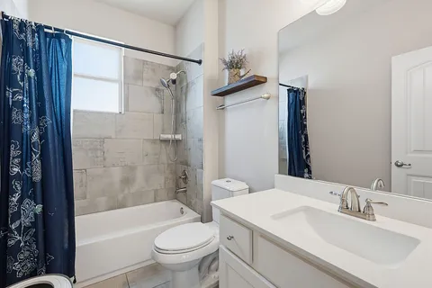 a bathroom with a double vanity sink mirror and shower