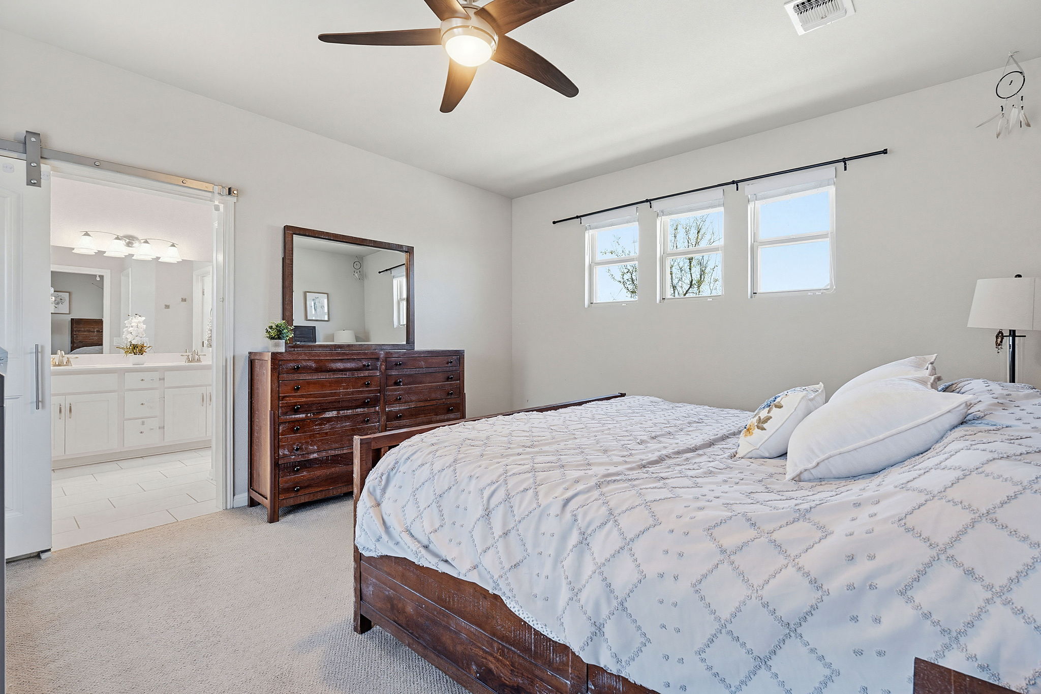 5820 Baythorne Drive Austin, TX 78747 - Photo 22 of 32 a bedroom with a bed and a chandelier