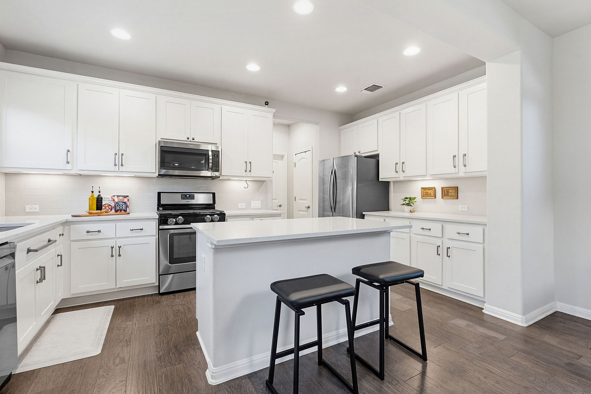 5820 Baythorne Drive Austin, TX 78747 - Photo 3 of 32 a kitchen with cabinets stainless steel appliances and a window