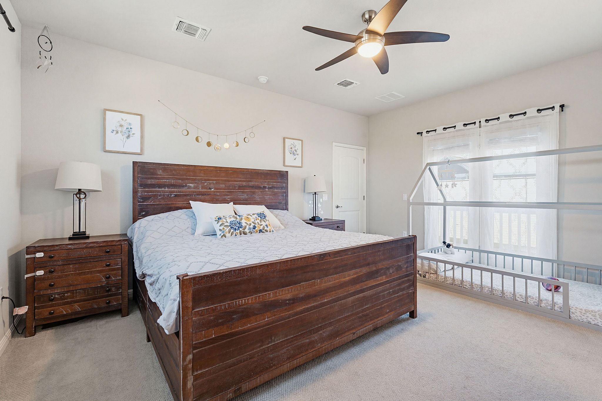 5820 Baythorne Drive Austin, TX 78747 - Photo 6 of 32 a bedroom with a bed and a chandelier