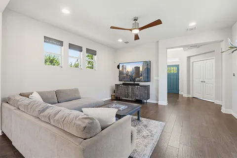 a living room with furniture and a wooden floor