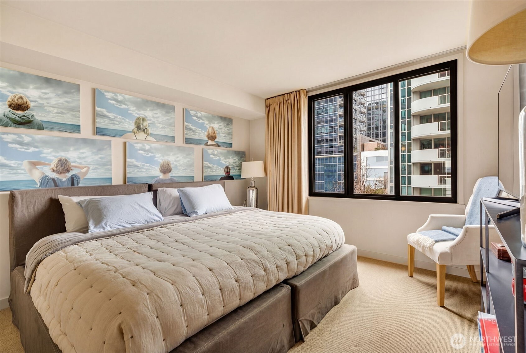 2021 1st Avenue, Unit E8 Seattle, WA 98121 - Photo 24 of 32 a bedroom with a large bed and a large window