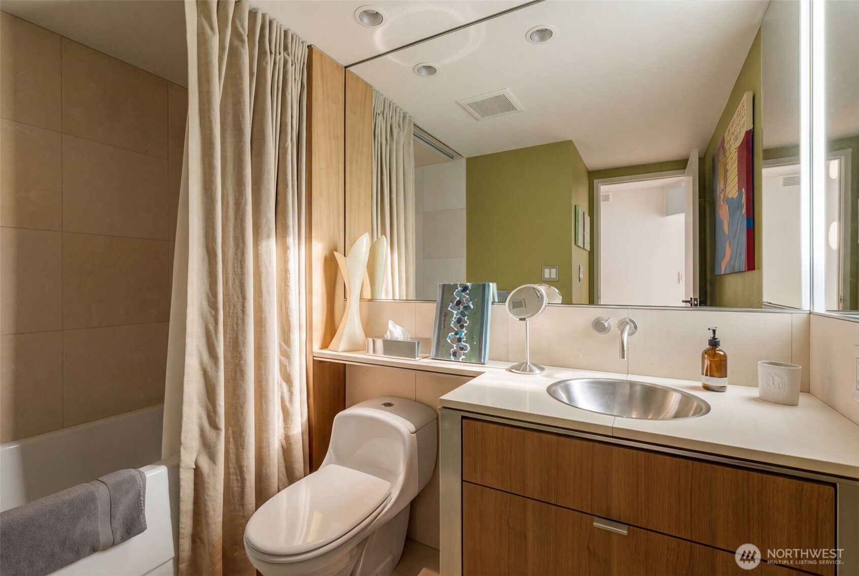 2021 1st Avenue, Unit E8 Seattle, WA 98121 - Photo 25 of 32 a bathroom with a sink a toilet and mirror