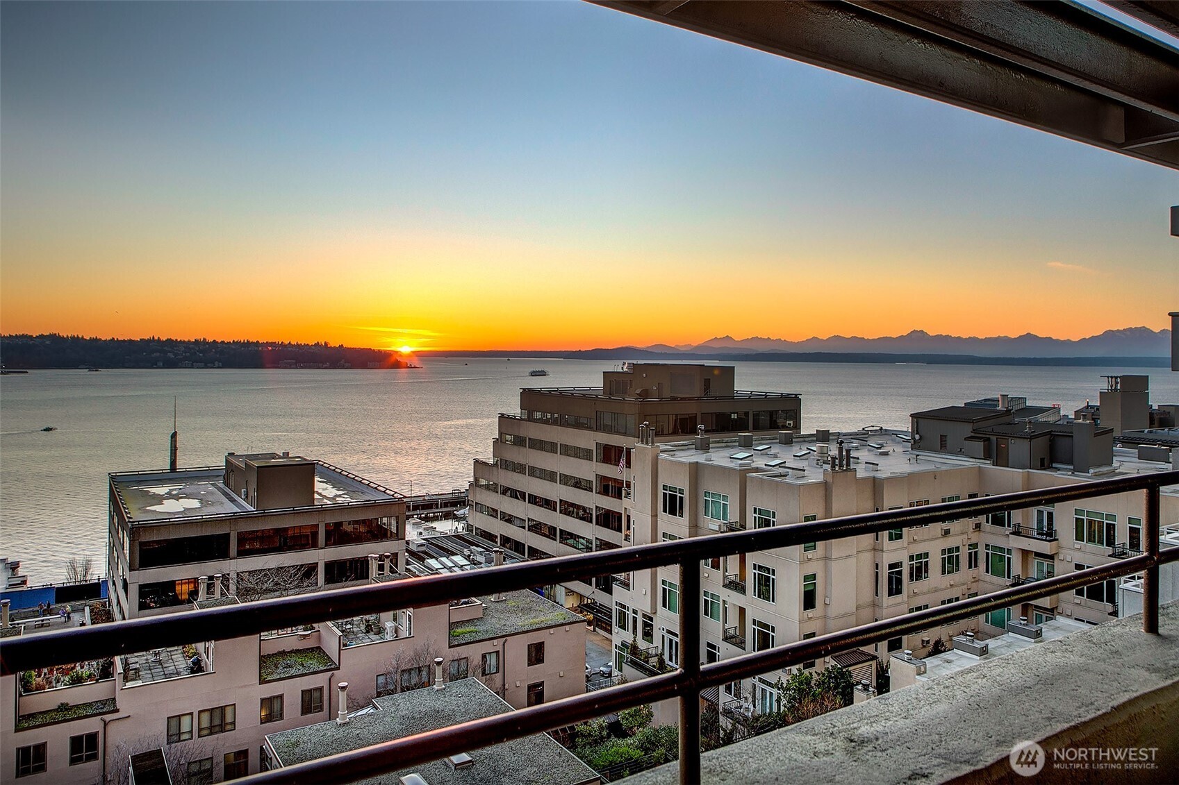 2021 1st Avenue, Unit E8 Seattle, WA 98121 - Photo 27 of 32 a view of a balcony with two chairs and a gate