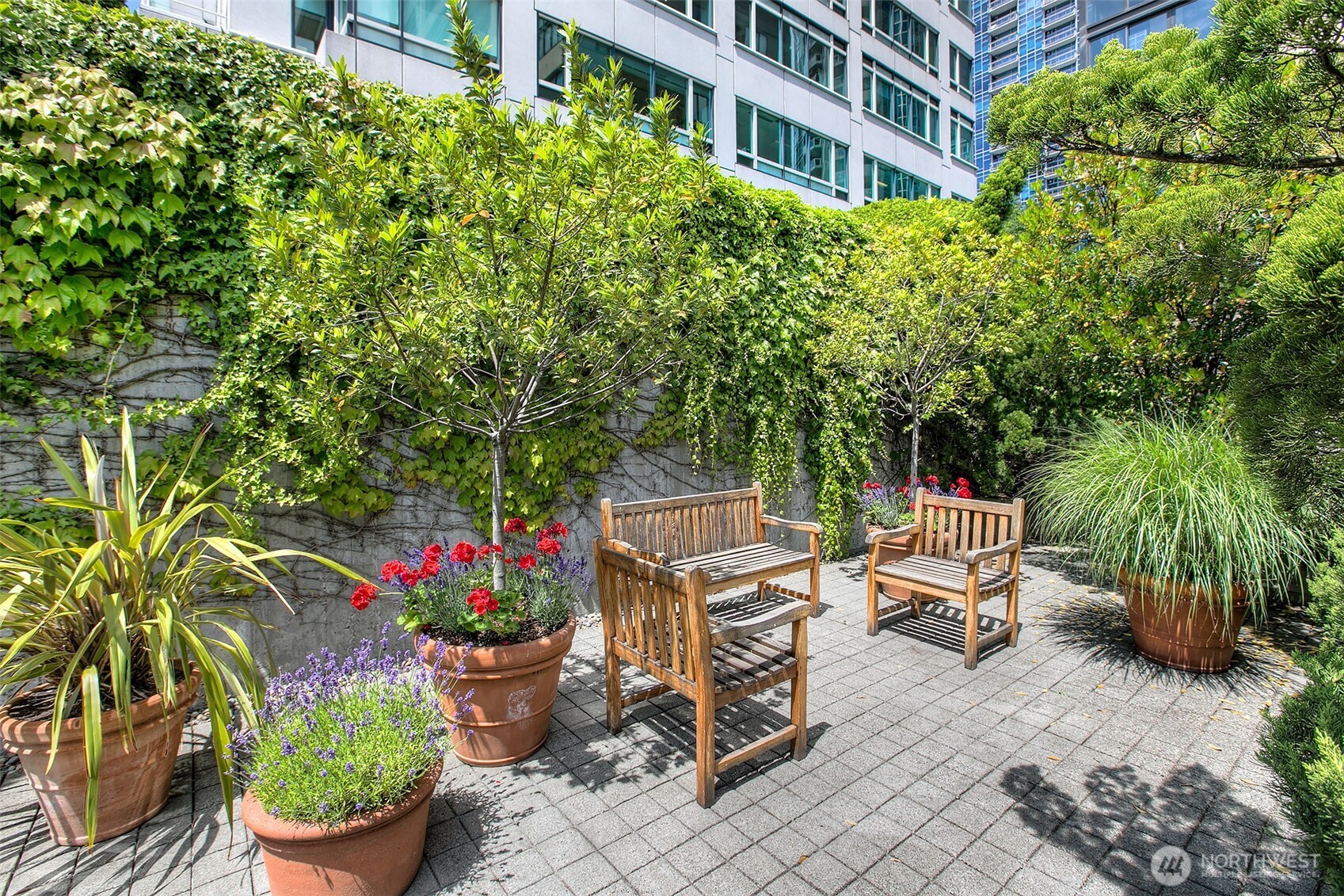 2021 1st Avenue, Unit E8 Seattle, WA 98121 - Photo 30 of 32 a backyard with plants and outdoor seating