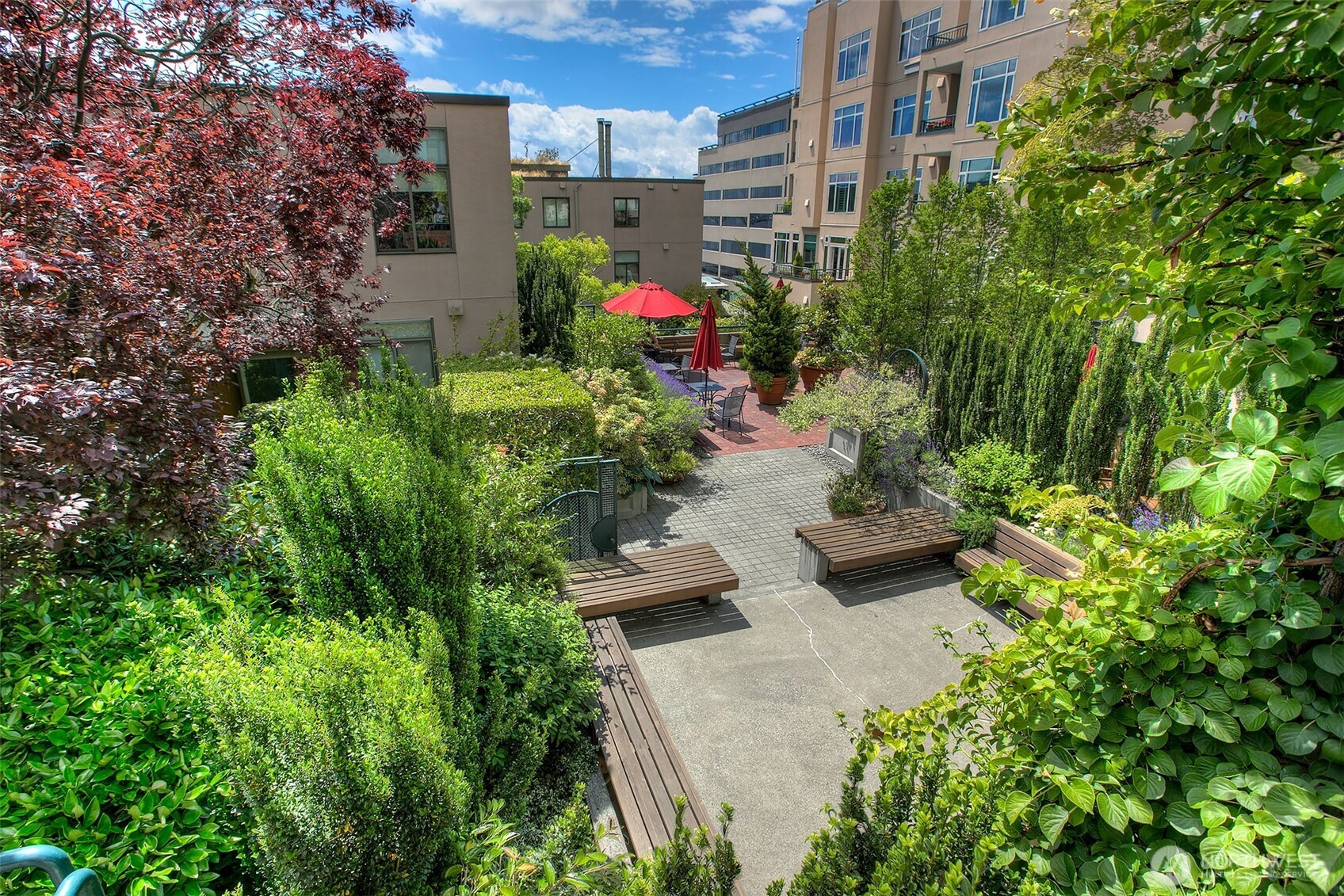 2021 1st Avenue, Unit E8 Seattle, WA 98121 - Photo 31 of 32 a view of a garden with chairs and flower plants