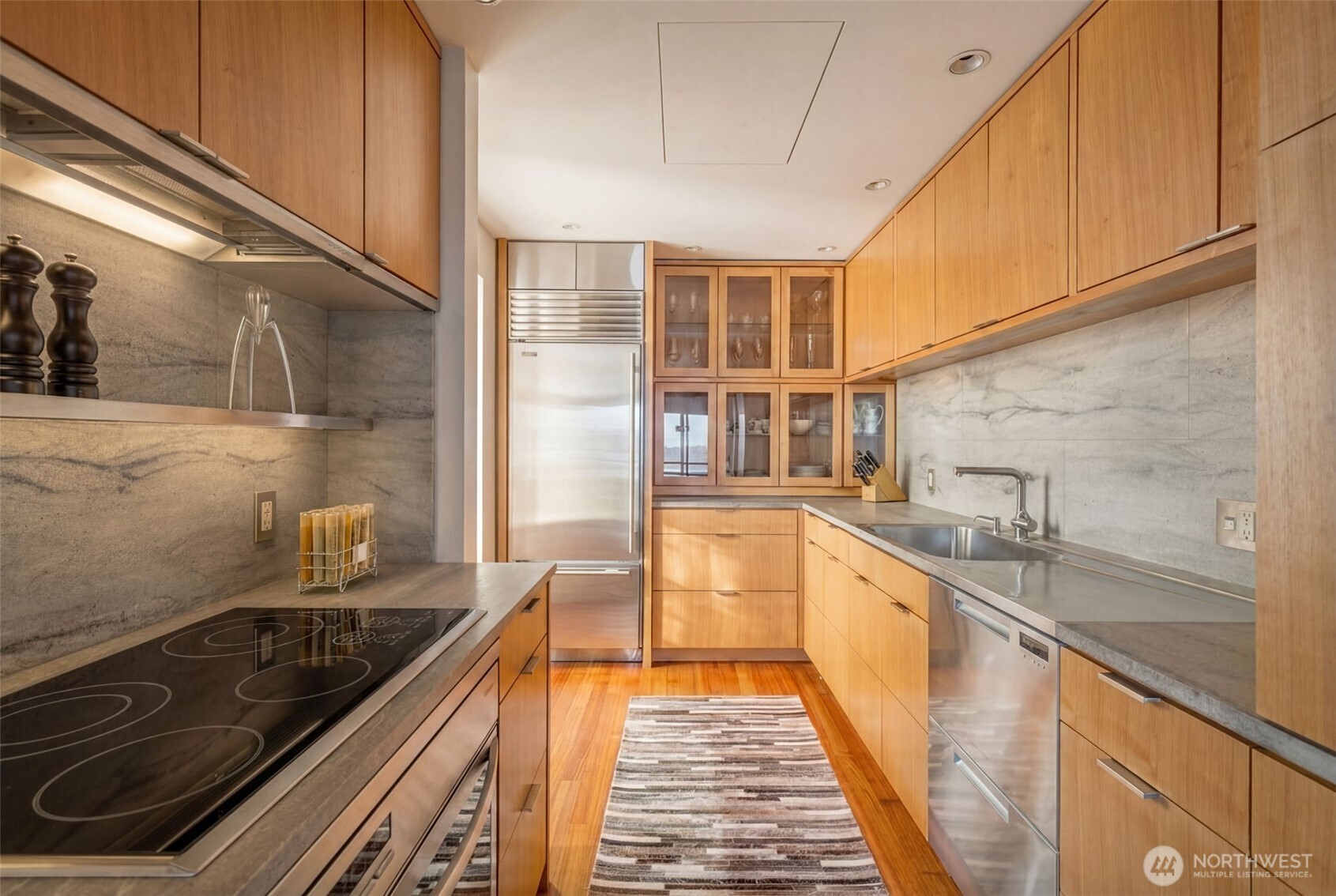 2021 1st Avenue, Unit E8 Seattle, WA 98121 - Photo 5 of 32 a kitchen with stainless steel appliances granite countertop a sink and cabinets