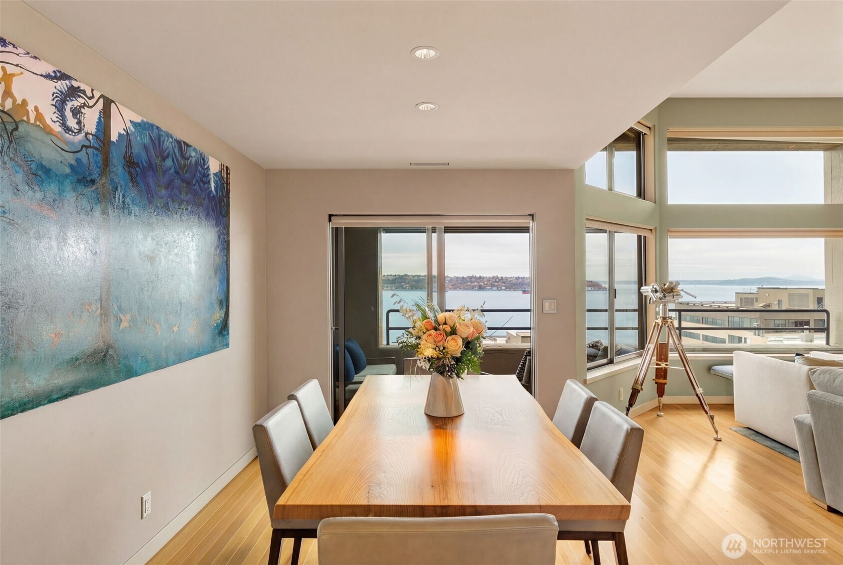 2021 1st Avenue, Unit E8 Seattle, WA 98121 - Photo 10 of 32 a view of a dining room with furniture window and wooden floor