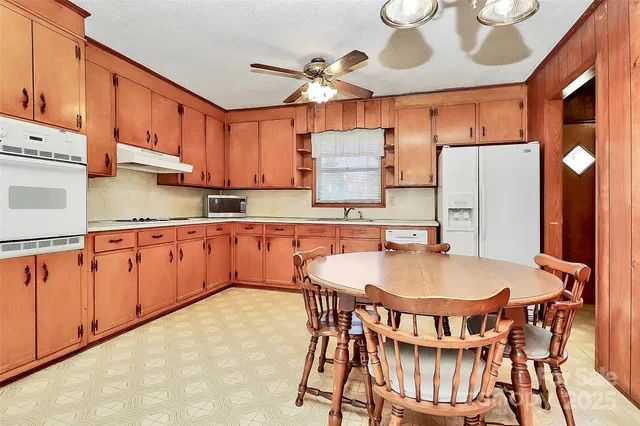 a kitchen with stainless steel appliances a refrigerator and a stove