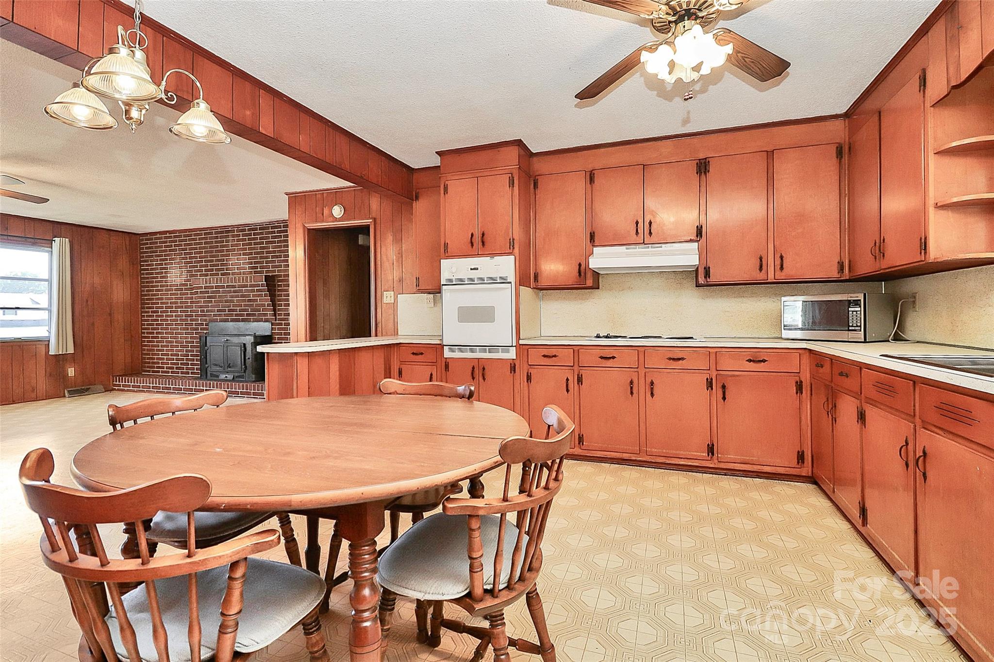 6217 Stack Road Monroe, NC 28112 - Photo 14 of 37 a kitchen with stainless steel appliances kitchen island granite countertop a dining table chairs sink and cabinets
