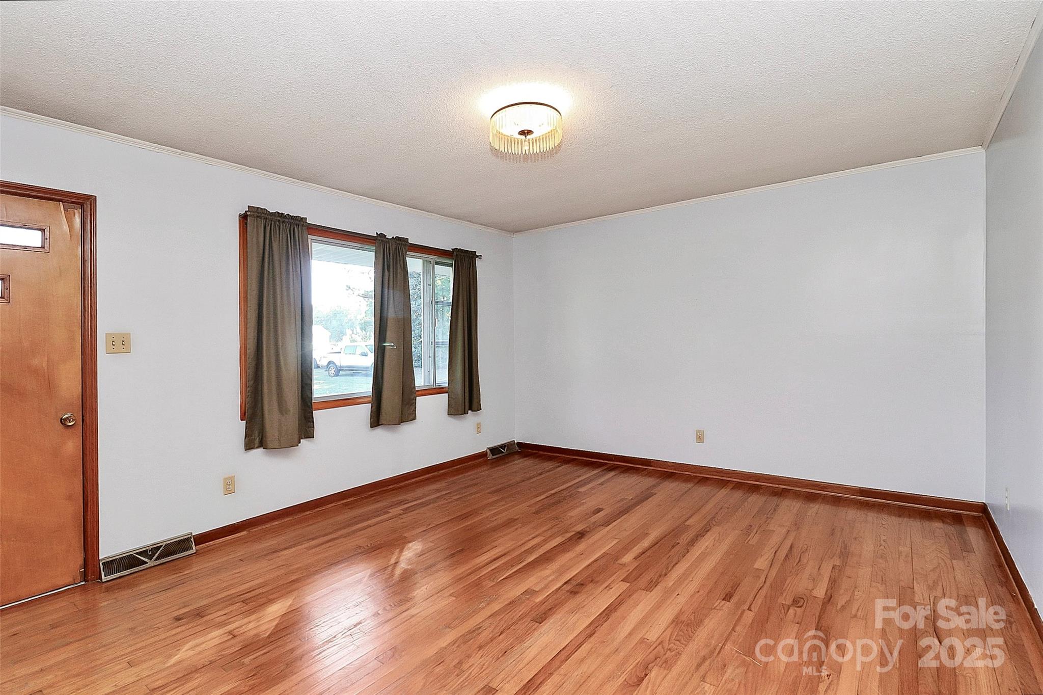 6217 Stack Road Monroe, NC 28112 - Photo 16 of 37 a view of an empty room with wooden floor and windows