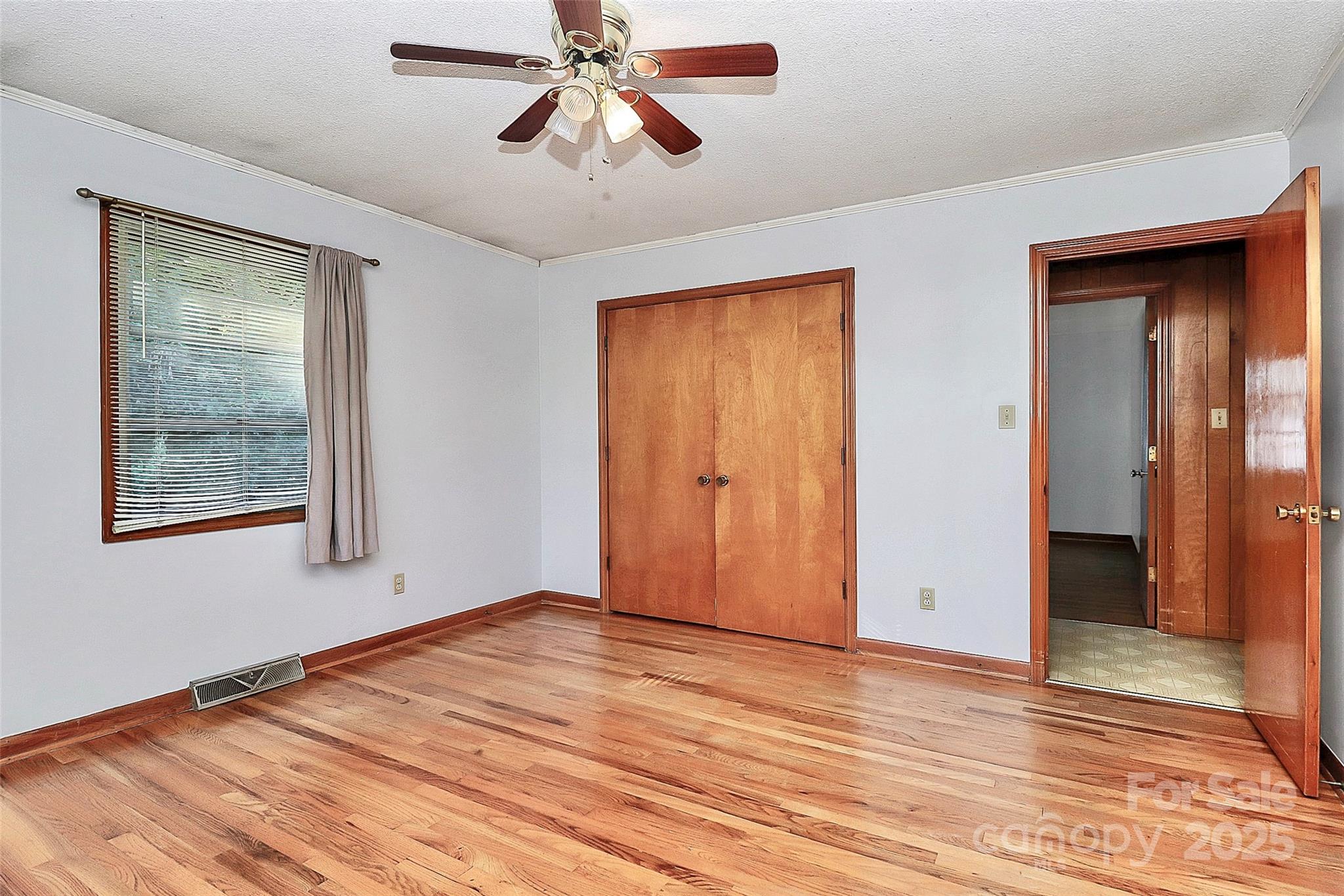 6217 Stack Road Monroe, NC 28112 - Photo 21 of 37 a view of an empty room with wooden floor and a ceiling fan