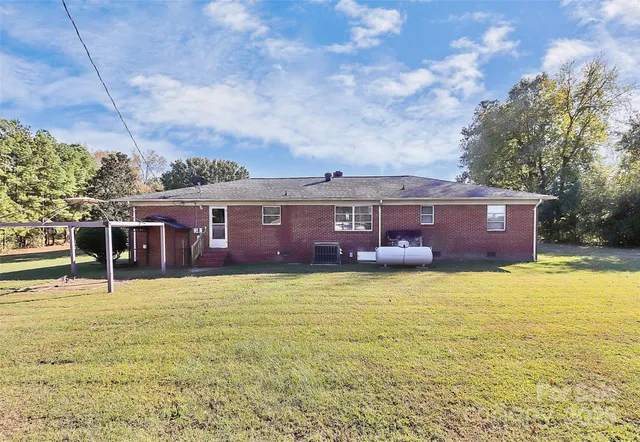 a view of a house with swimming pool and a yard